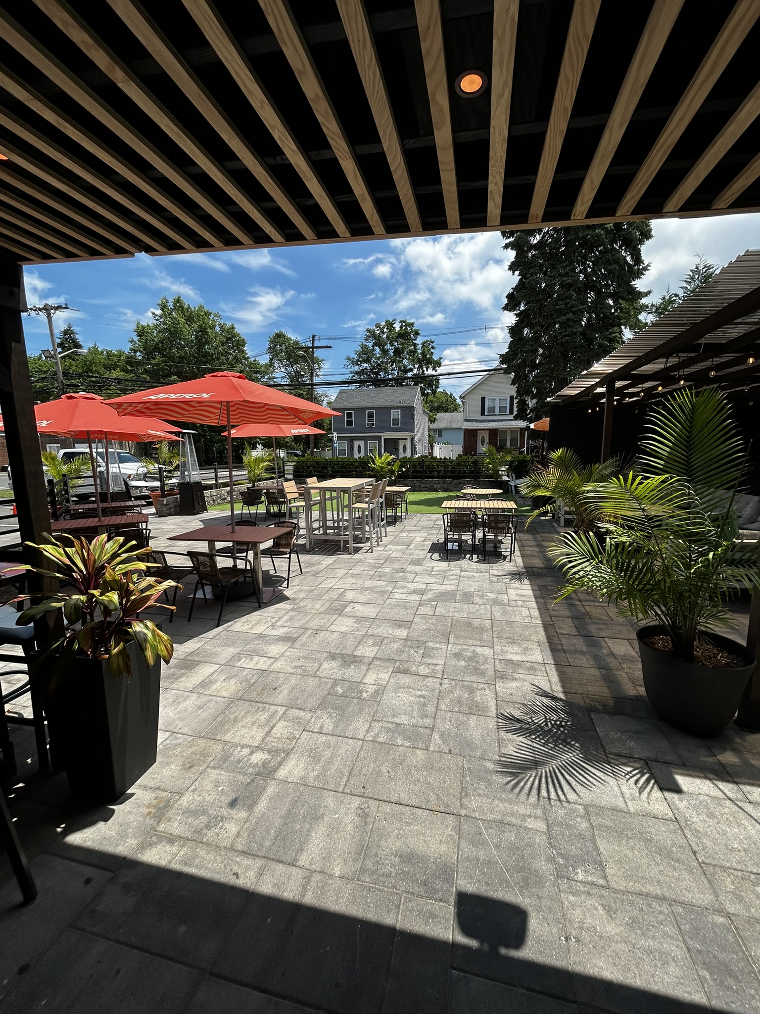 The outdoor patio at A Salute, with umbrellas and seasonal planting